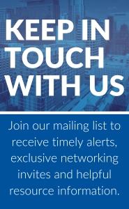 The image is a promotional graphic with the following text:  Top Section:  "KEEP IN TOUCH WITH US" Bottom Section:  "Join our mailing list to receive timely alerts, exclusive networking invites and helpful resource information." The background of the top section shows a cityscape with a blue overlay, making the text stand out in white. The bottom section has a solid blue color with white text.